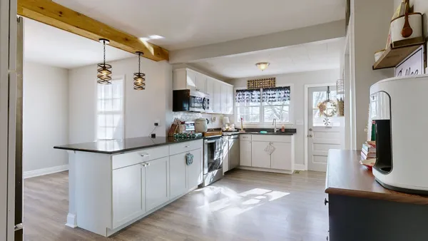 a kitchen with stainless steel appliances kitchen island granite countertop a refrigerator and a sink