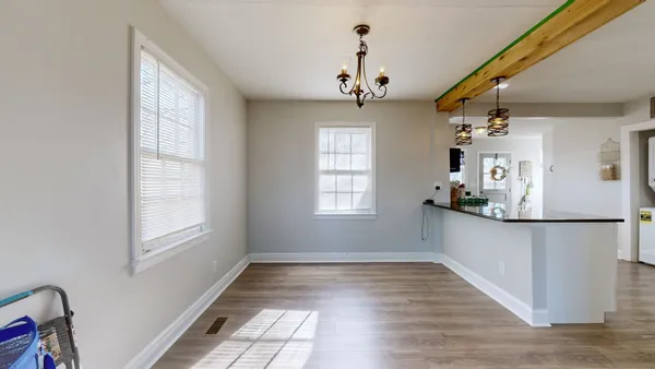 a view of a room with wooden floor and windows