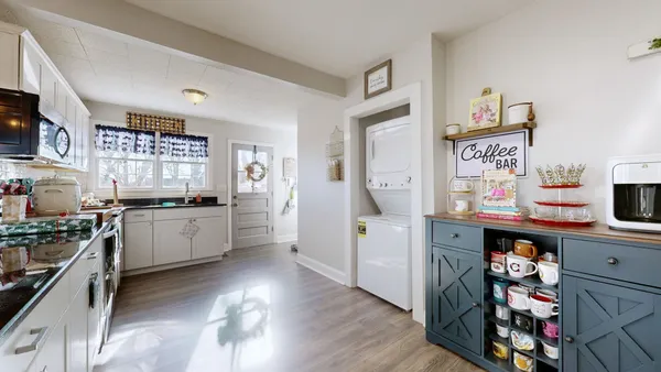 a kitchen with stainless steel appliances a stove top oven a sink a counter space and cabinets