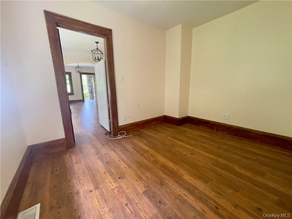 4 Old Turnpike Road Bloomingburg, NY 12721 - Photo 21 of 27 Unfurnished room featuring a notable chandelier and dark hardwood / wood-style floors