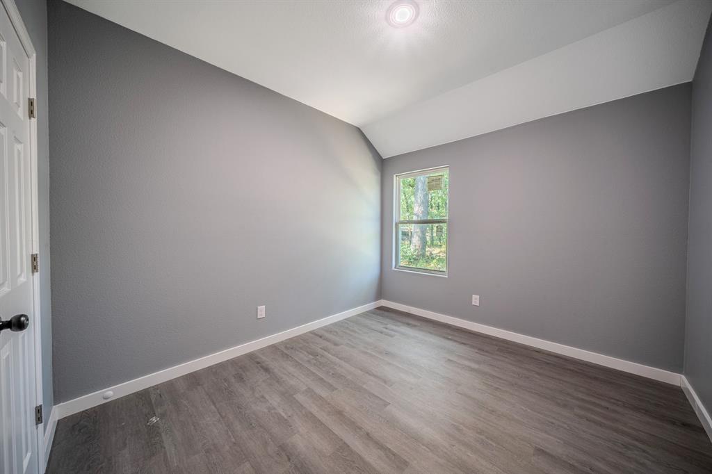 110 Red Oak Mabank, TX 75156 - Photo 16 of 30 a view of an empty room with wooden floor and a window