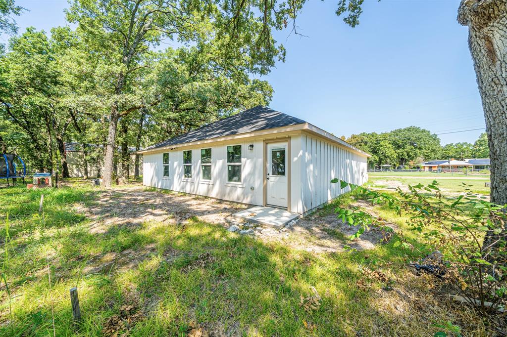 110 Red Oak Mabank, TX 75156 - Photo 22 of 30 a view of a house with backyard and trees