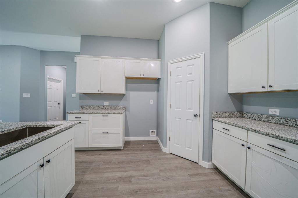110 Red Oak Mabank, TX 75156 - Photo 8 of 30 a kitchen with granite countertop white cabinets and white appliances