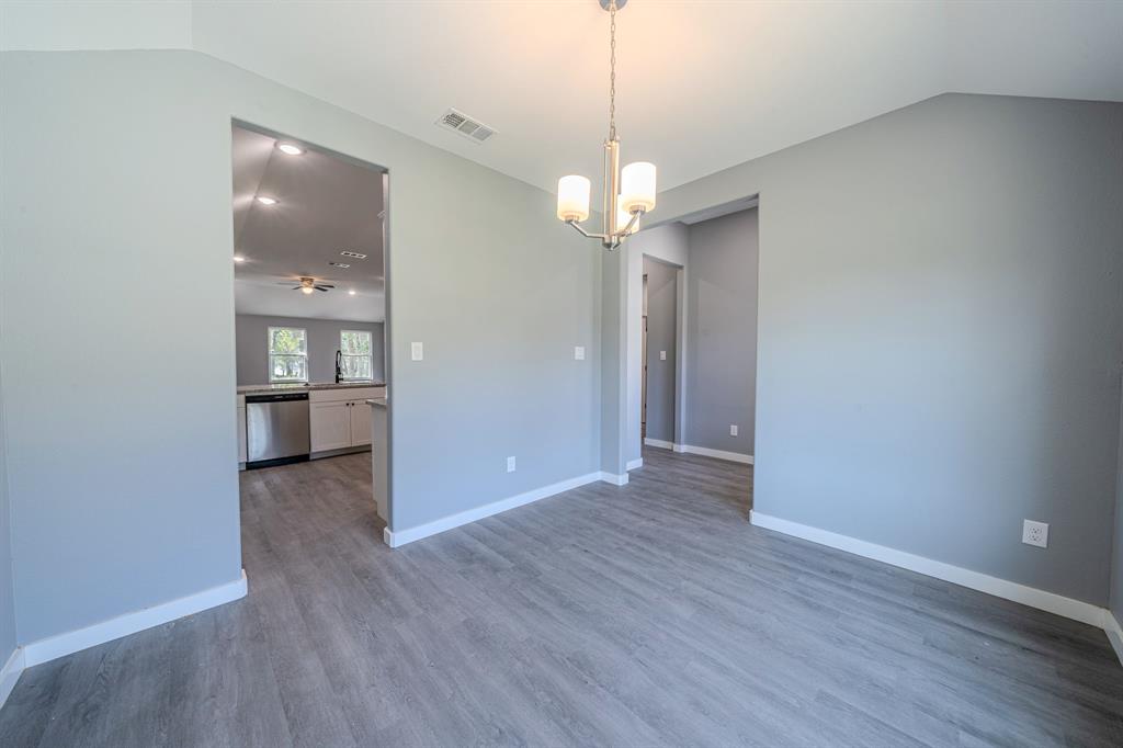 110 Red Oak Mabank, TX 75156 - Photo 10 of 30 a view of a hallway with wooden floor and a chandelier