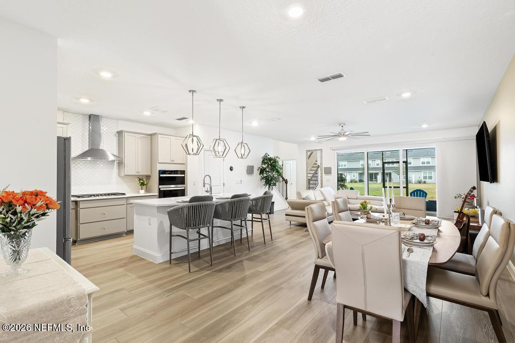 a large kitchen with a table and chairs