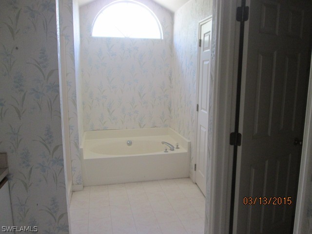 5615 Marina Road Bokeelia, FL 33922 - Photo 11 of 12 a en suite bathroom with a bathtub and a shower