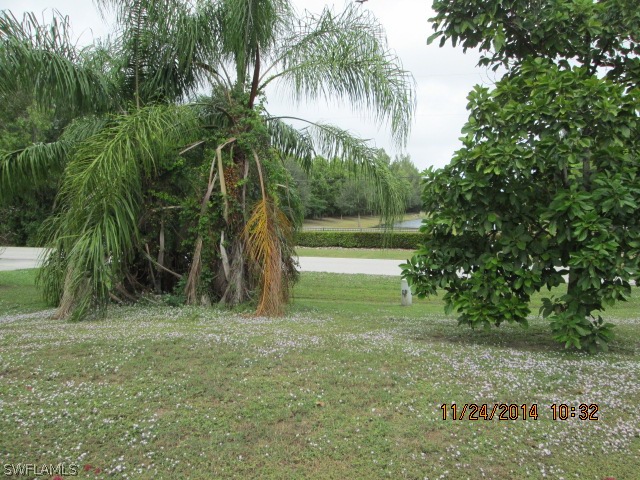 5615 Marina Road Bokeelia, FL 33922 - Photo 3 of 12 a backyard of a house with table and chairs