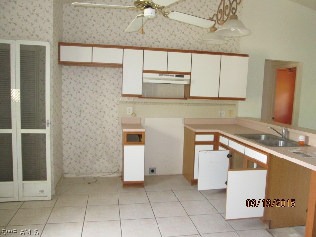 5615 Marina Road Bokeelia, FL 33922 - Photo 9 of 12 a kitchen with a sink and cabinets