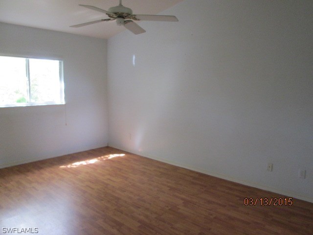5615 Marina Road Bokeelia, FL 33922 - Photo 10 of 12 wooden floor in an empty room with a window