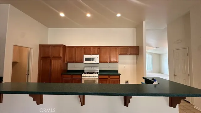 a kitchen with kitchen island sink and refrigerator