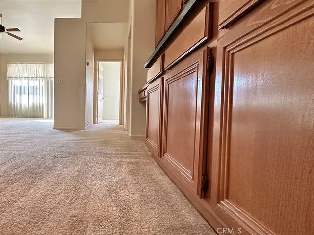 a view of a hallway with wooden floor and windows