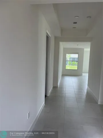 a view of an empty room and a window