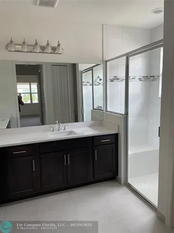 a bathroom with a granite countertop sink mirror and double