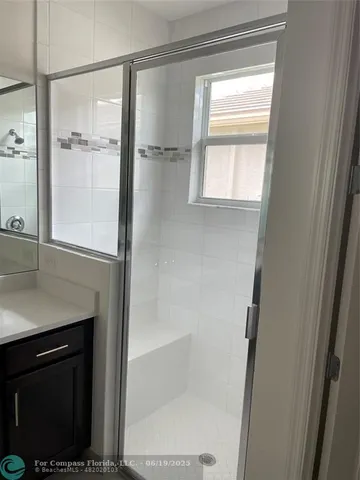 a bathroom with a shower and a window