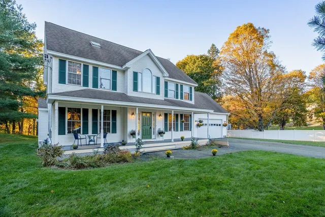 a front view of a house with a yard table and chairs