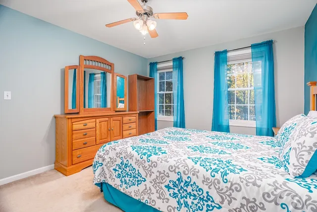 a bedroom with a bed dresser and a window