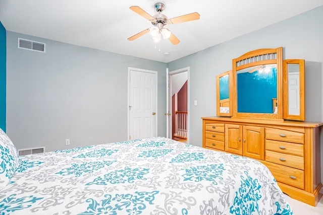 a bedroom with a bed and a dresser