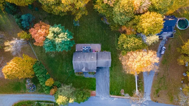a view of a house with backyard and porch