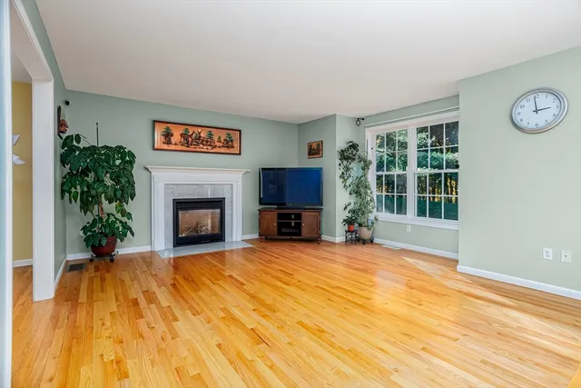 a view of a livingroom with an empty space and a fireplace