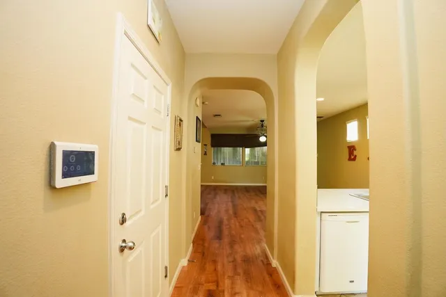 a view of a hallway with wooden floor