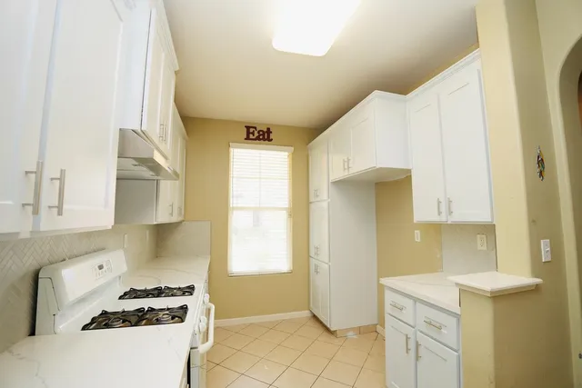a kitchen with a stove a refrigerator and a sink