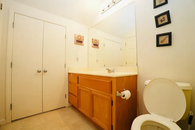 a bathroom with a sink mirror and toilet