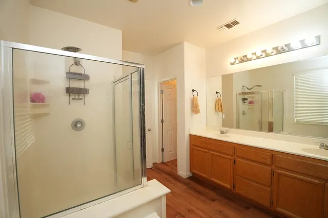 a bathroom with a glass shower door and a mirror
