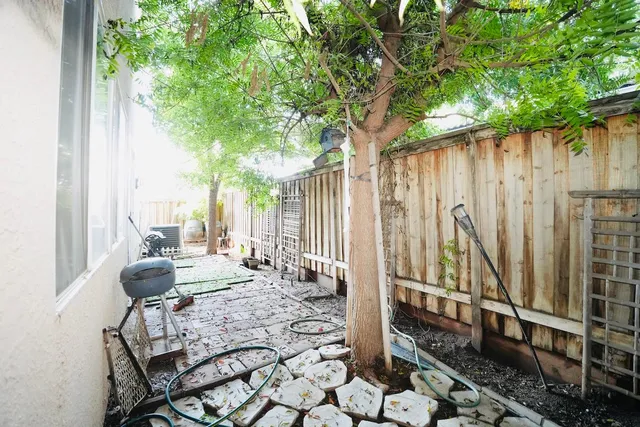 a view of balcony with chairs and table of a patio