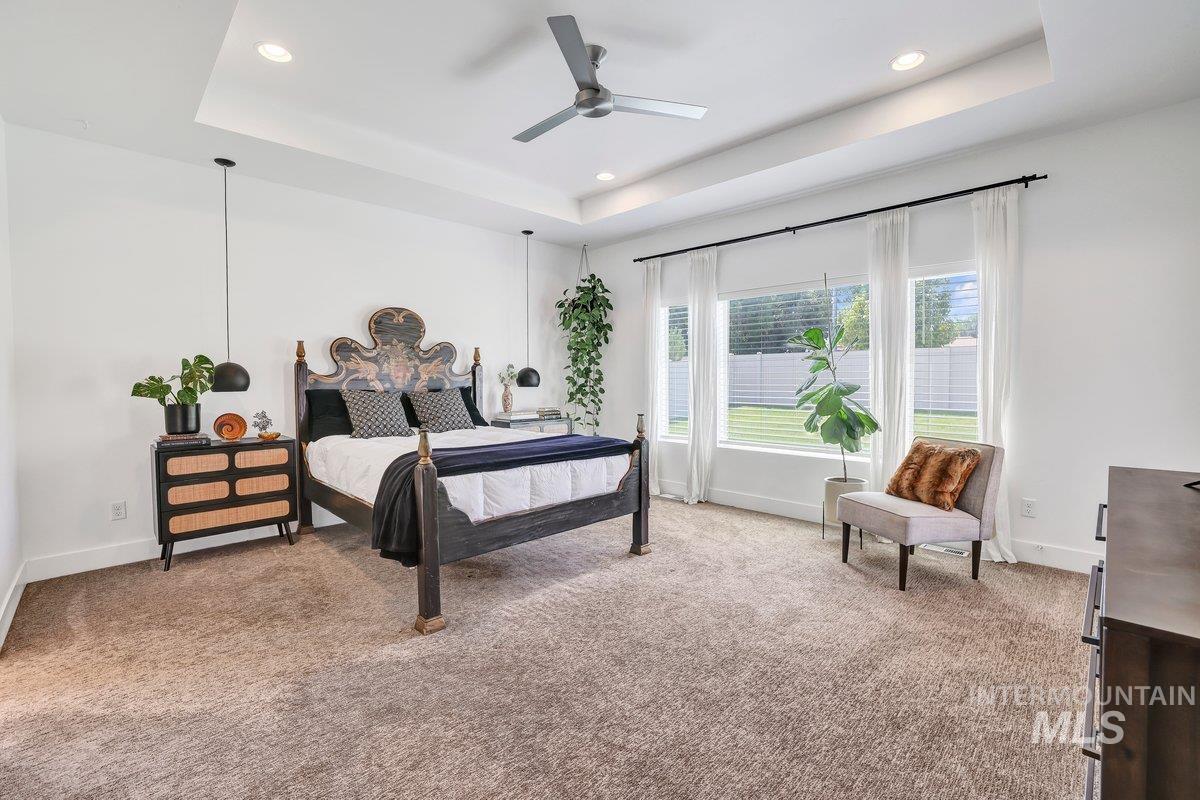 957 Birchton Loop Twin Falls, ID 83301 - Photo 13 of 32 Bedroom with a raised ceiling, light carpet, recessed lighting, and ceiling fan