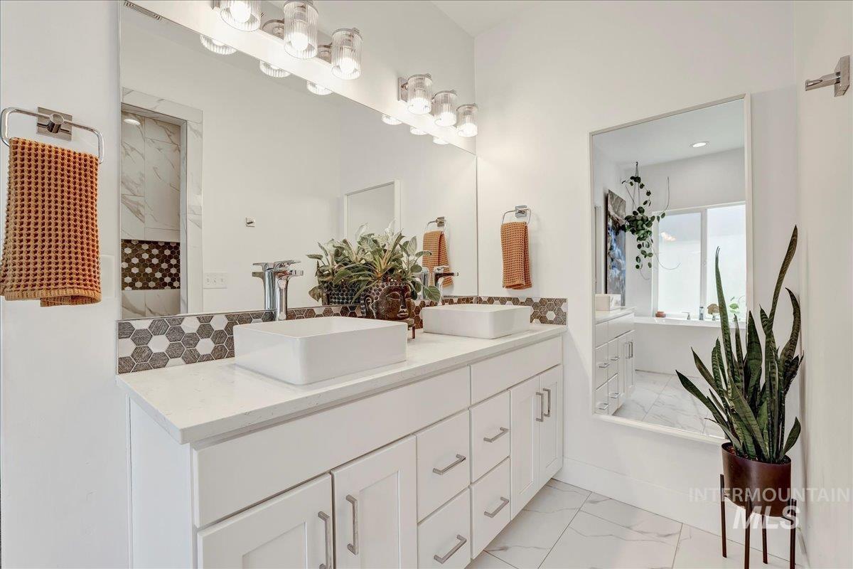 957 Birchton Loop Twin Falls, ID 83301 - Photo 18 of 32 Full bath featuring marble finish floors, double vanity, and a tile shower