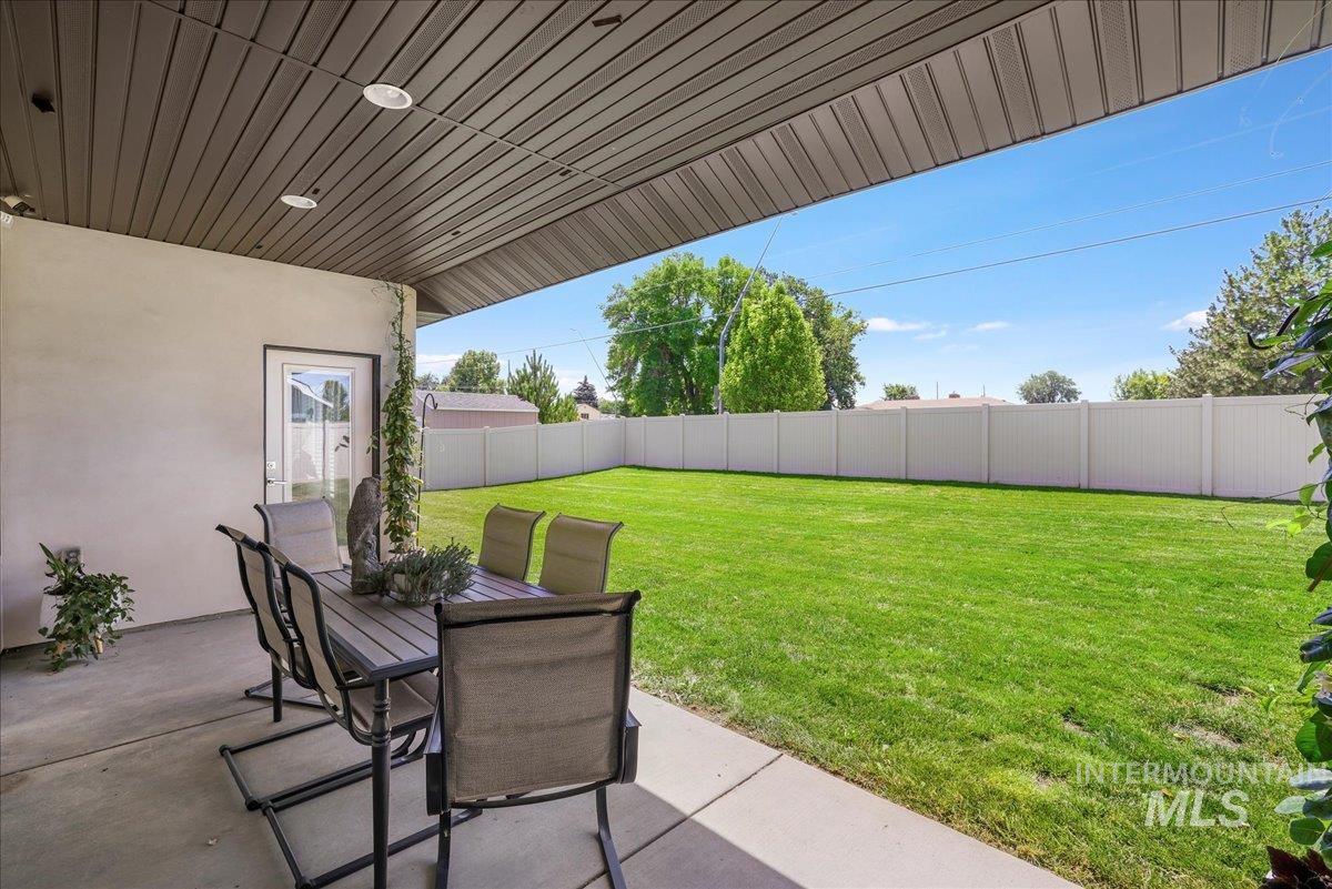 957 Birchton Loop Twin Falls, ID 83301 - Photo 27 of 32 Fenced backyard with a patio area and outdoor dining space