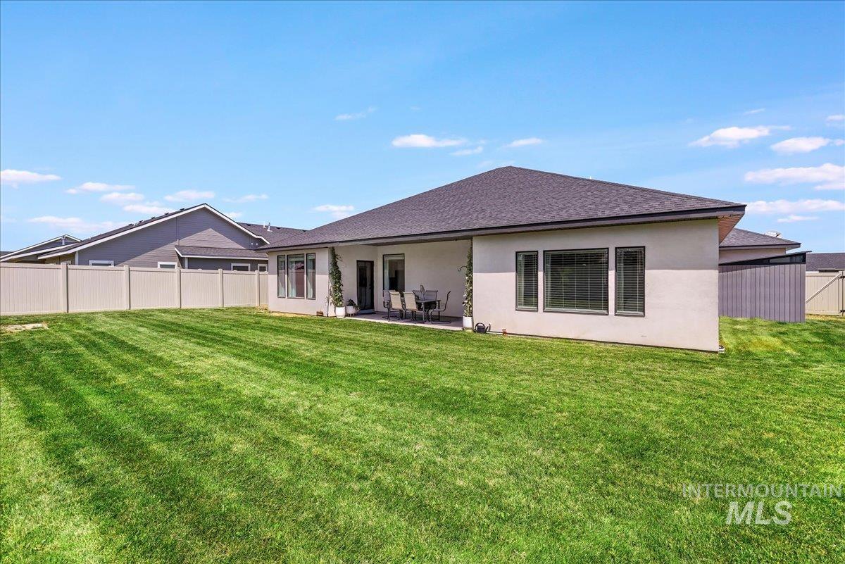957 Birchton Loop Twin Falls, ID 83301 - Photo 32 of 40 Back of house with a patio area, roof with shingles, and stucco siding