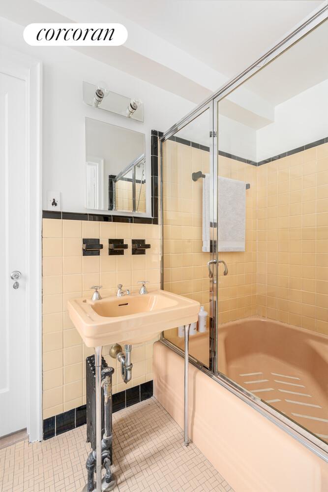 5 Riverside Drive, Unit 5A Manhattan, NY 10023 - Photo 9 of 13 a bathroom with a sink and a mirror