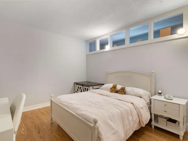 a bedroom with a bed and a chair