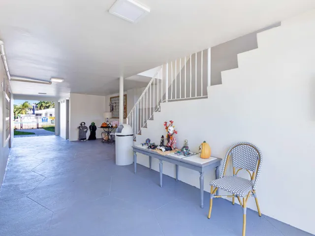 a living room with furniture and stairs