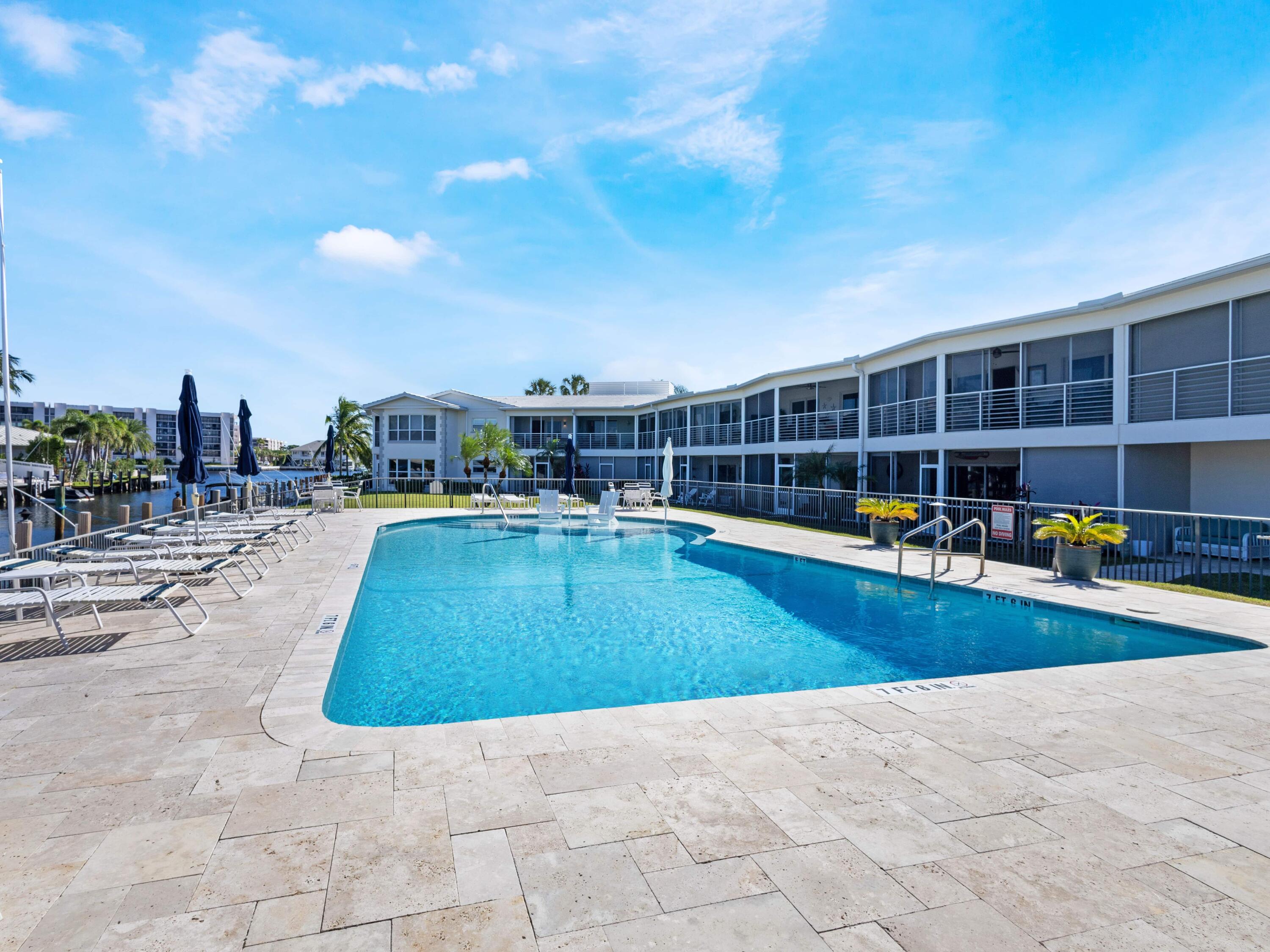 701 Harbour Drive, Unit 2140 Boca Raton, FL 33431 - Photo 26 of 35 a view of a swimming pool with a lounge chair
