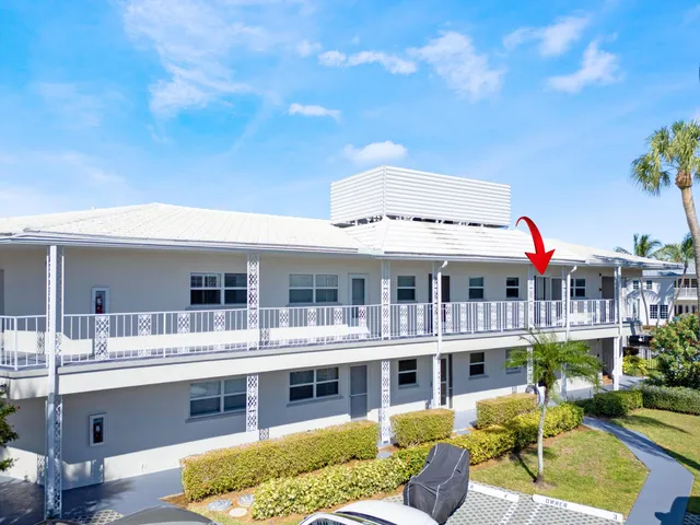 a view of a building with a garden and potted plants