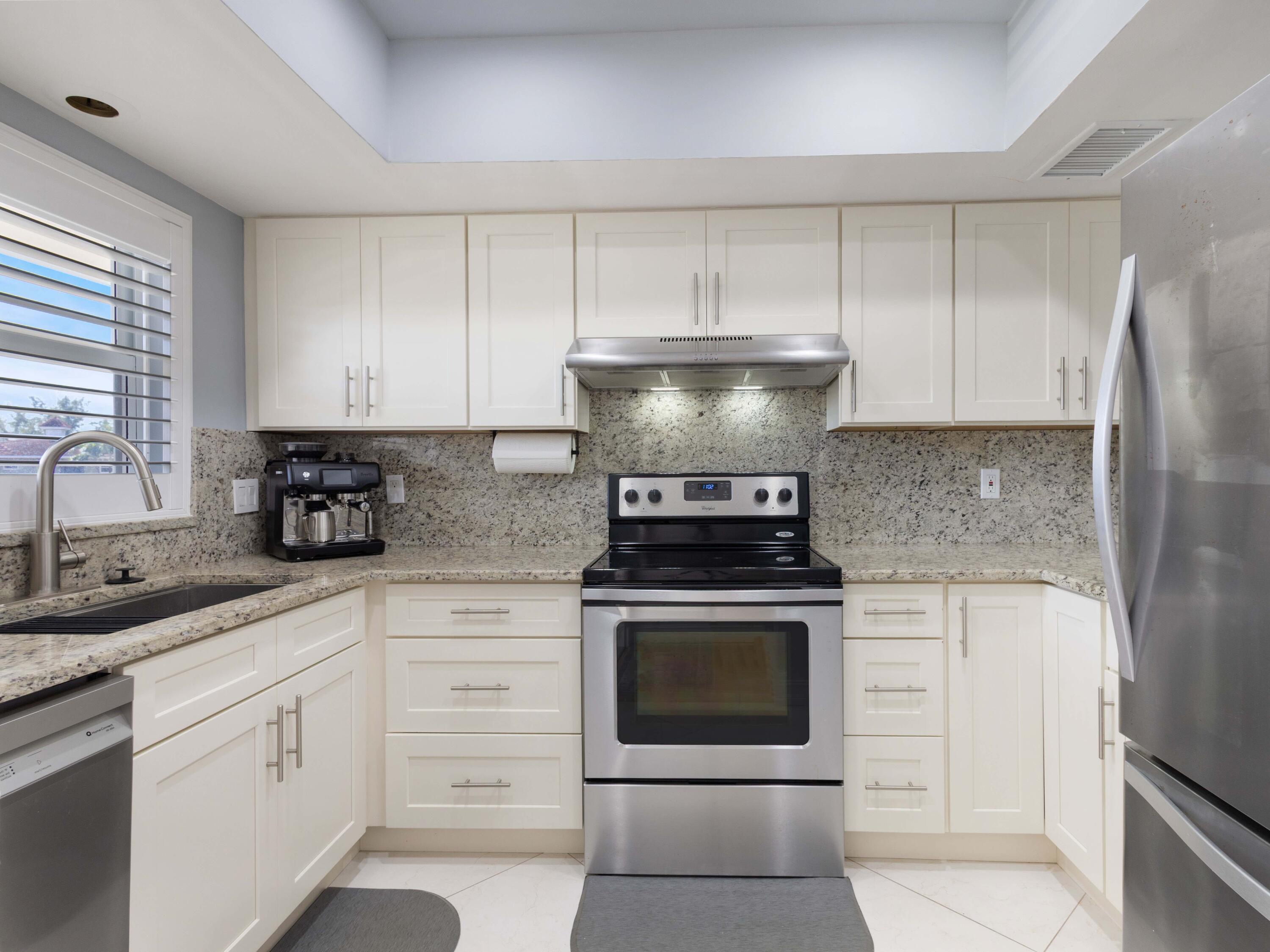701 Harbour Drive, Unit 2140 Boca Raton, FL 33431 - Photo 6 of 35 a kitchen with cabinets appliances and a sink