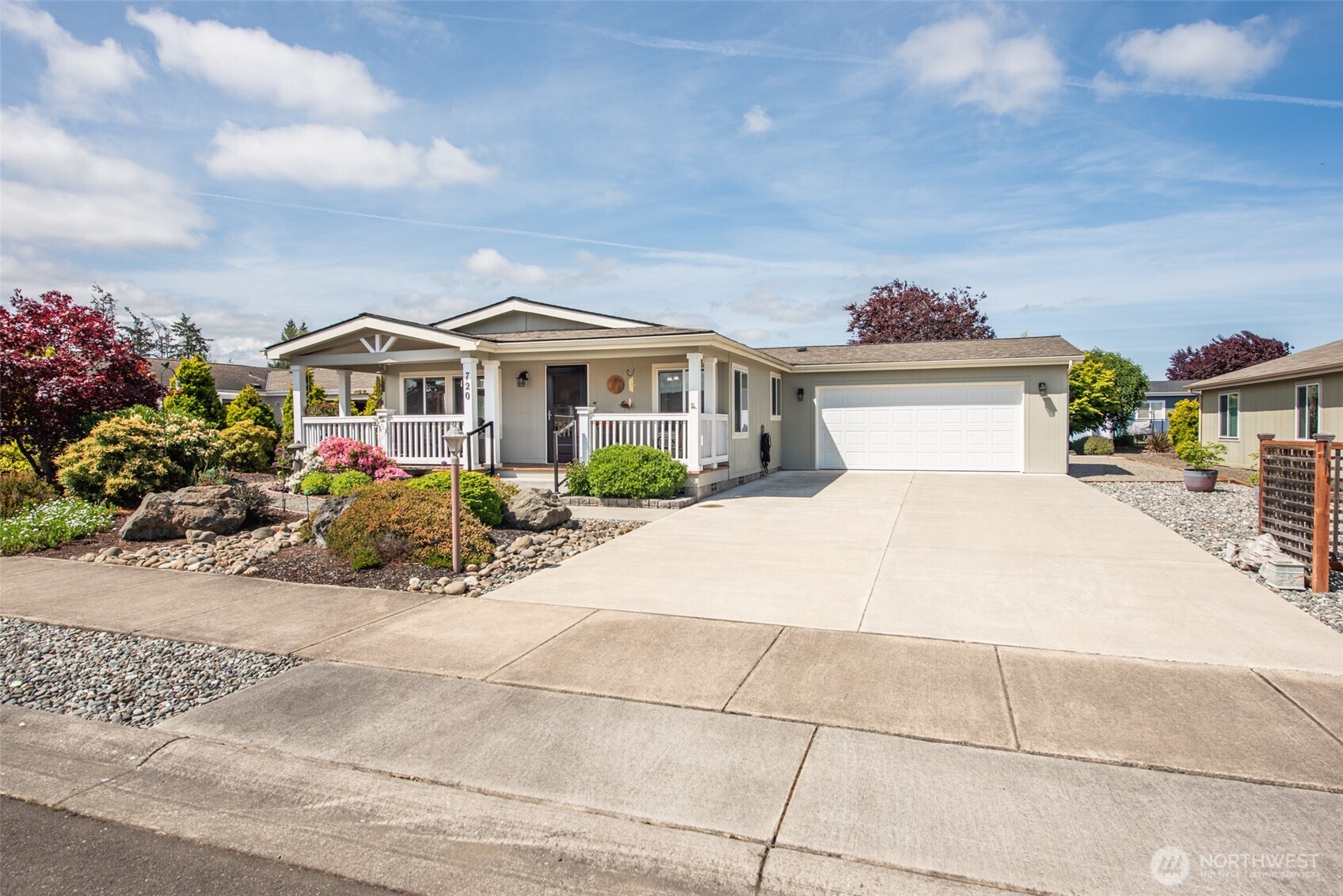 720 West Heritage Loop Sequim, WA 98382 - Photo 1 of 35 a front view of a house with a garden