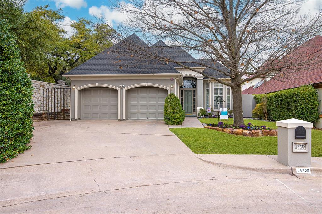 a front view of a house with yard and green space