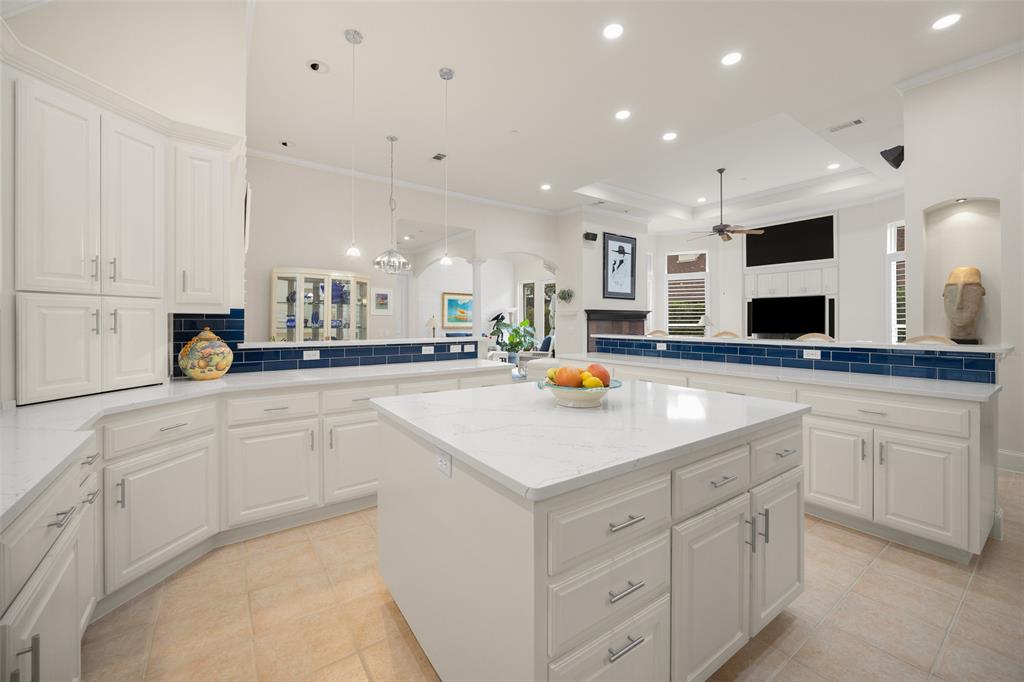 14725 Celestial Place Addison, TX 75254 - Photo 14 of 38 a kitchen with stainless steel appliances kitchen island granite countertop a sink a stove and cabinets