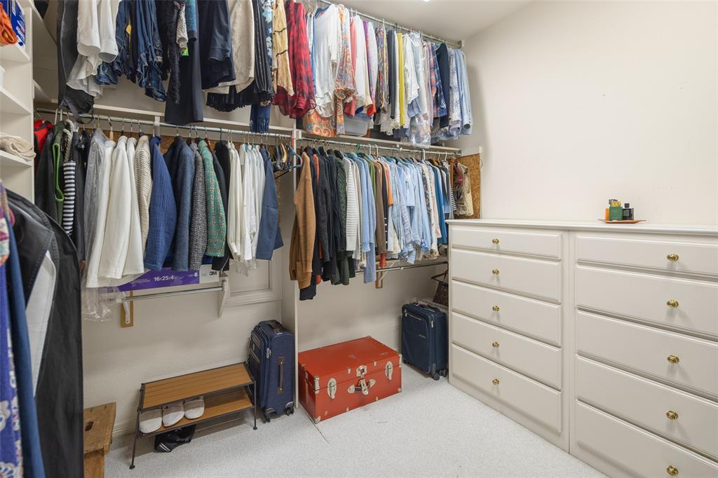 14725 Celestial Place Addison, TX 75254 - Photo 15 of 38 a view of walk in closet with clothes and shoes