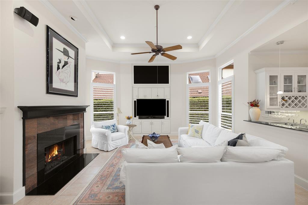 14725 Celestial Place Addison, TX 75254 - Photo 16 of 38 a living room with furniture a fireplace and a flat screen tv