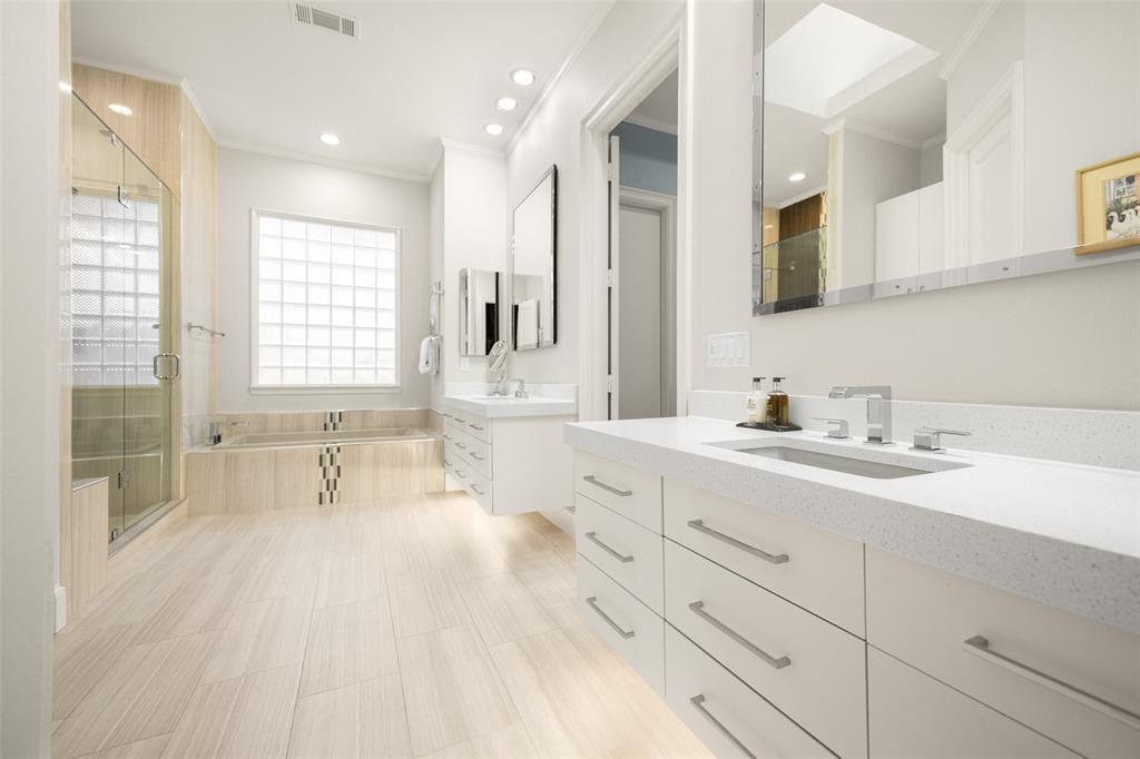 14725 Celestial Place Addison, TX 75254 - Photo 27 of 38 a spacious bathroom with double vanity a a mirror a vanity and a bathtub