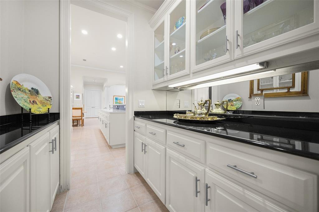 14725 Celestial Place Addison, TX 75254 - Photo 9 of 38 a kitchen with white cabinets and appliances