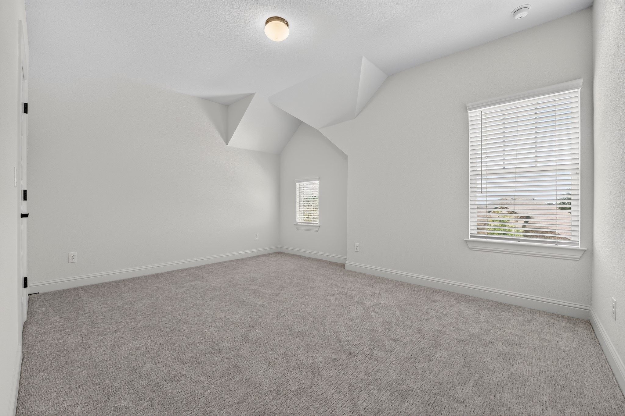 508 Pinnacle View Drive Georgetown, TX 78628 - Photo 13 of 27 A spacious room offers ample natural light and plush carpeting, perfect for a cozy retreat.