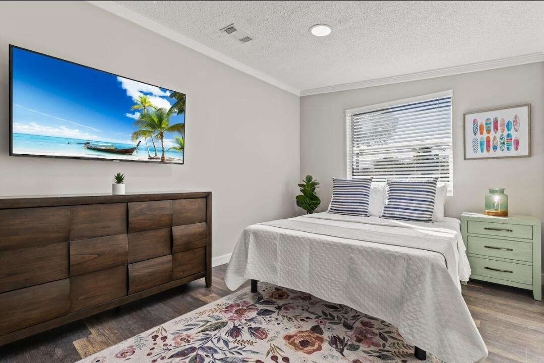 5607 Tangelo Drive Fort Pierce, FL 34982 - Photo 2 of 10 a bedroom with a bed and a window