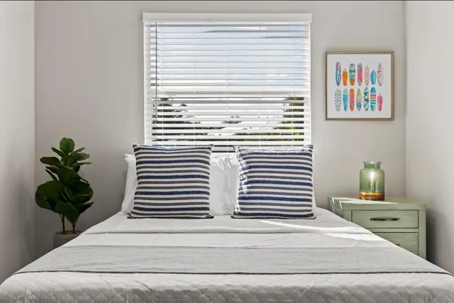 a view of a hallway with wooden floor and a potted plant