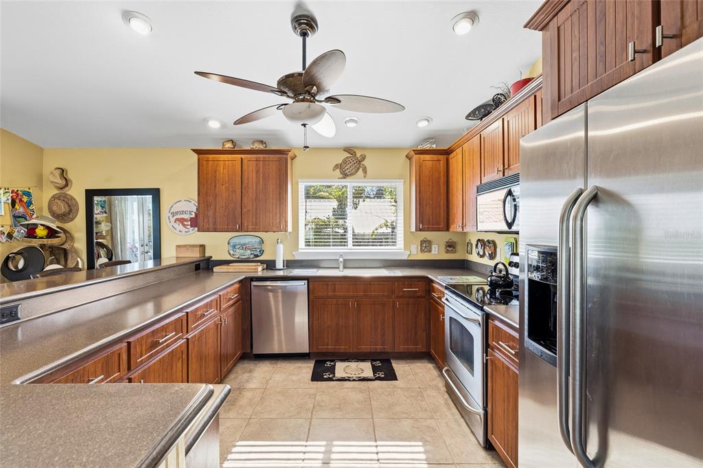 8550 Little Gasparilla Placida, FL 33946 - Photo 17 of 62 a kitchen with stainless steel appliances granite countertop a sink a stove and a refrigerator