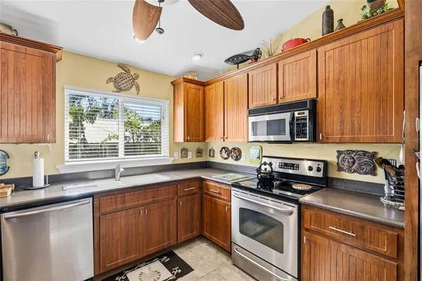a living room with furniture kitchen view and a chandelier